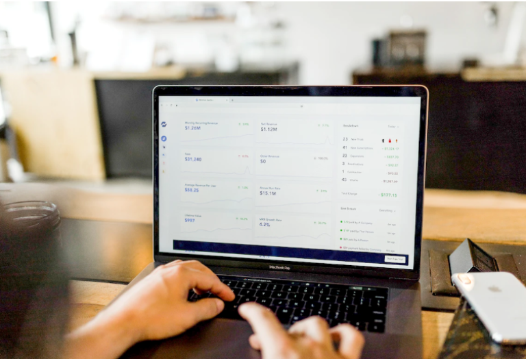 A business person using laptop to check and monitor revenue
